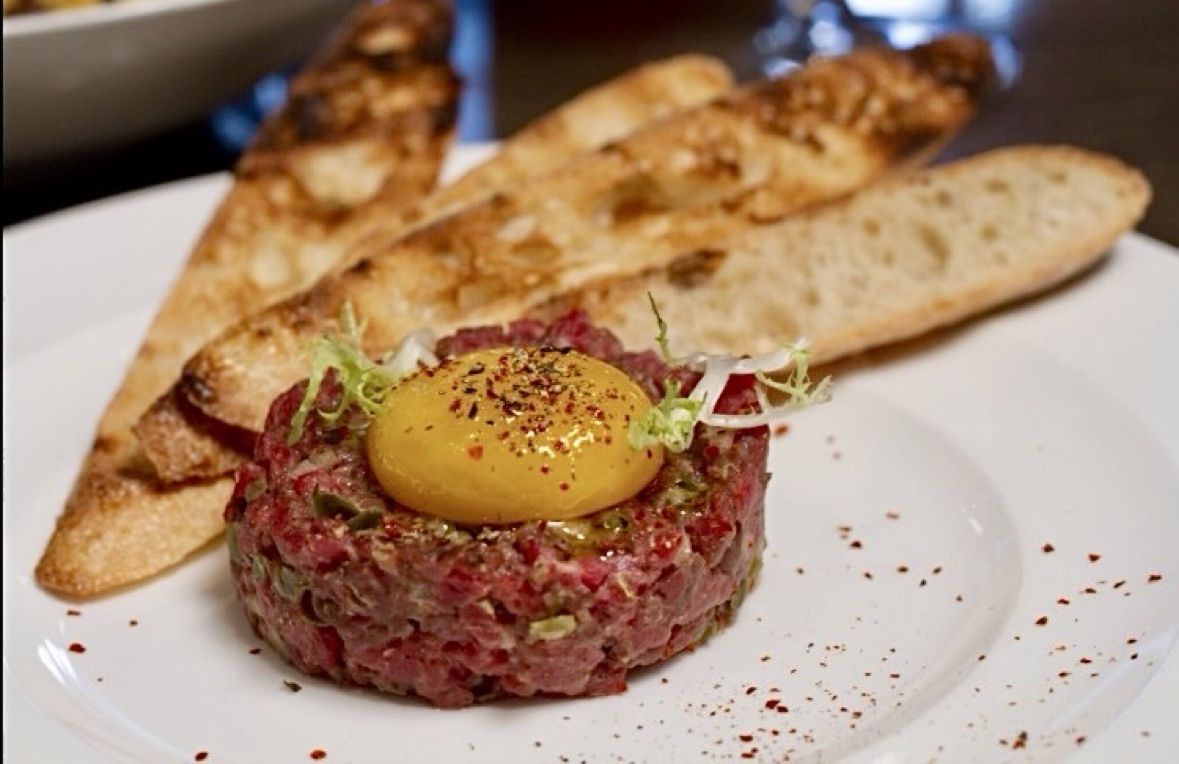Hand cut beef tartare with cured yolk and grilled bread