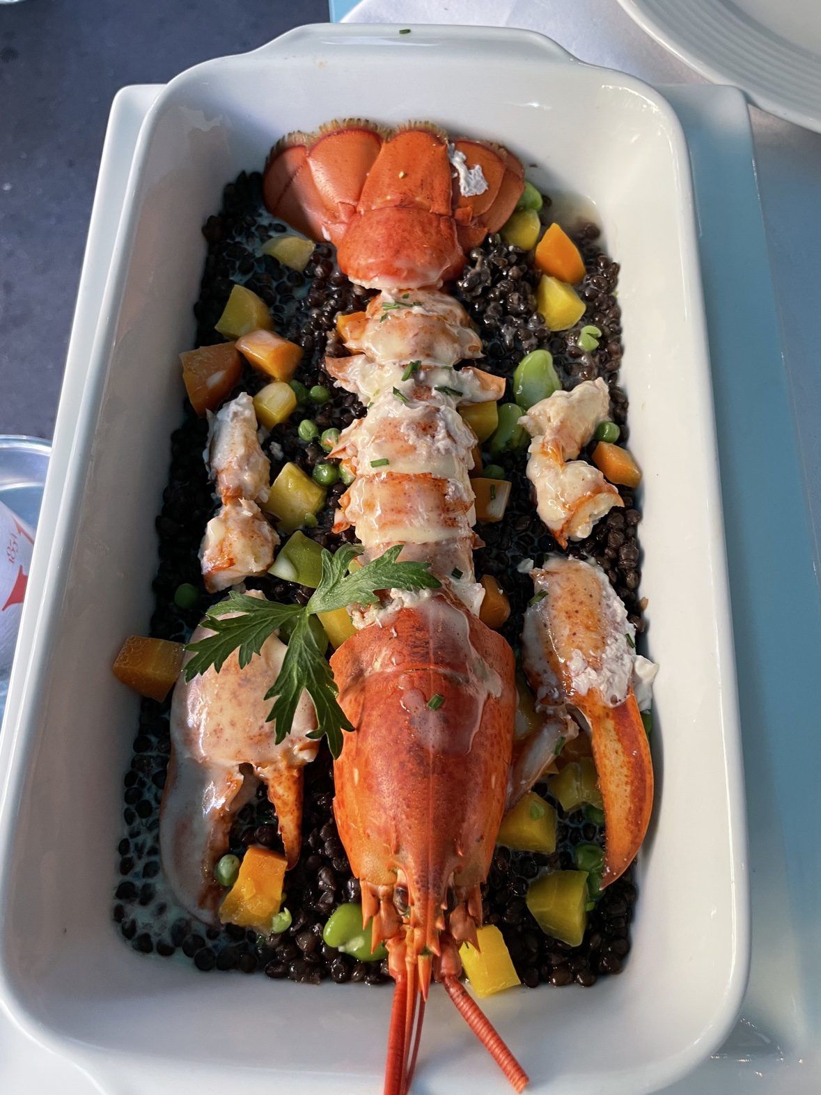 Whole lobster with black lentils