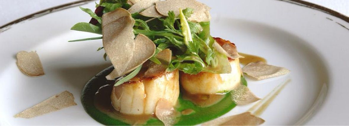 Seared scallops with shaved truffle and herb salad