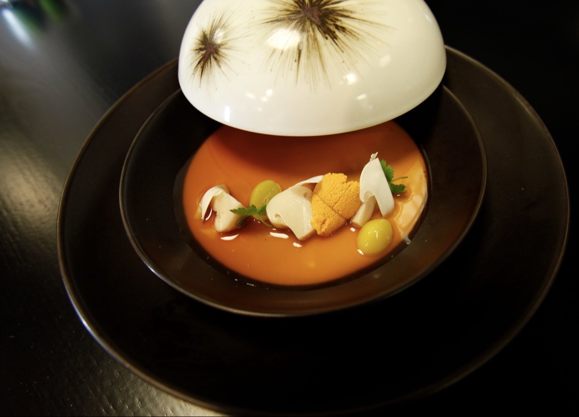 Sea urchin and scallop consommé under a cloche