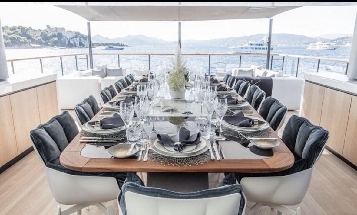 Long alfresco table set for guests on deck